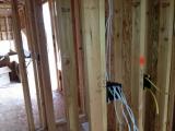 Standing in office looking through mud room and pantry into lounge where boxes are
