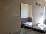 First mirror in place in master bathroom