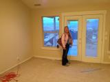 Lesley-Ann in master bedroom with carpet being laid