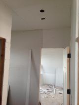 Sheetrock - looking into office from hall way with garage on the right