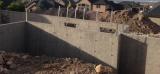Basement Shell - View from front showing back of Garages where Office will be and Kitchen to the left