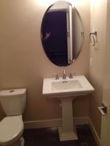 Half bath assembled with oval mirror