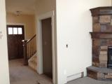 Entrance, stairs to baasement and fireplace in lounge