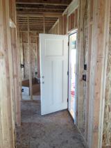 Door to Garage from hallway opposite Mud Room, the Office is at the end of the Hallway
