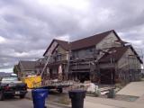 A storm is coming in and the workers have to move fast to finish the shakes in apex