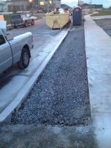 Curb cut-away and gravel laid for concrete