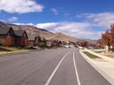 Our house is at the end of the road to the left, looks white walls with dark roof