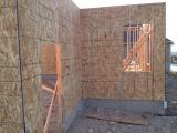 Outside garage door on left and office window in front