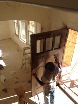 Front door being painted by workman