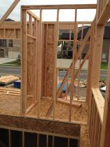 Stairwell at front, front door on left and half bathroom on right