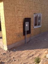 Side of single garage with electric box