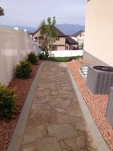 View looking down from side gate into back garden, with Air Conditioning units on the right
