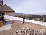 That evergreen is going down behind the fire pit