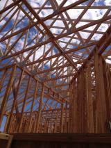 Trusses above upstairs hallway with master bedroom on left and 2nd bedroom on right looking from standing  halfway downstairs