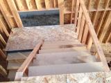 Standing at top of stairs looking down staircase to ground floor