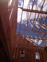 Looking up from the kitchen and nook at trusses above lounge and laundry