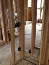 Standing in music room looking through to entrance and stairs on left down to basement