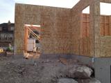 Garage door in front with office on right