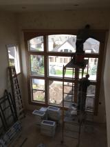 Workers preparing great room for painting