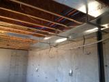 Workshop in basement showing duct and plumbing for ground floor