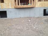 Wooden marks on ground show where the canopy posts will be for nook walk out