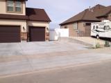 Completed driveway with upright concrete wall on right side